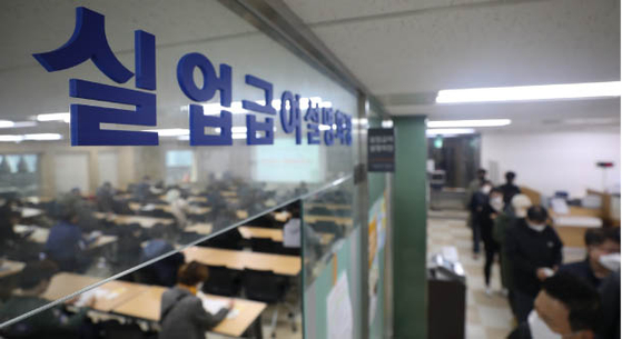 People sit in a room listening to a lecture on how to apply for government unemployment benefits on April 21, in the Work Plus Center located in Jung District central Seoul. [NEWS1]