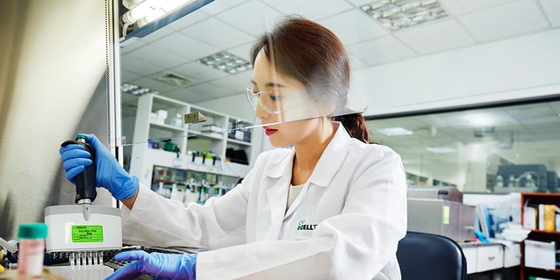 A Celltrion researcher tests for the development of Covid-19 antiviral antibody treatment in the laboratory. [CELLTRION]