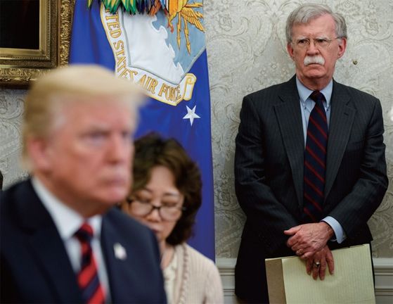 Former White House National Security Adviser John Bolton, right, looks at U.S. President Donald Trump, left, during a summit with South Korean President Moon Jae-in last year. [AP/YONHAP]