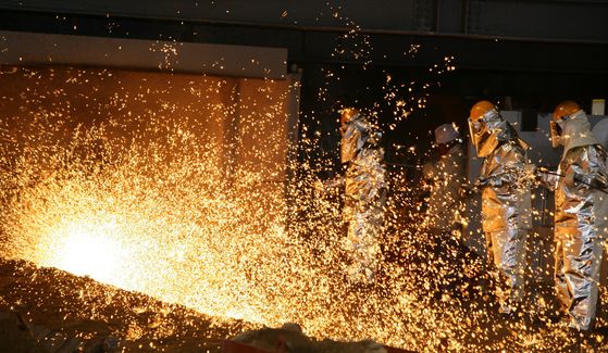 Workers make steel at Pohang Steel Works in North Gyeongsang. [POSCO]