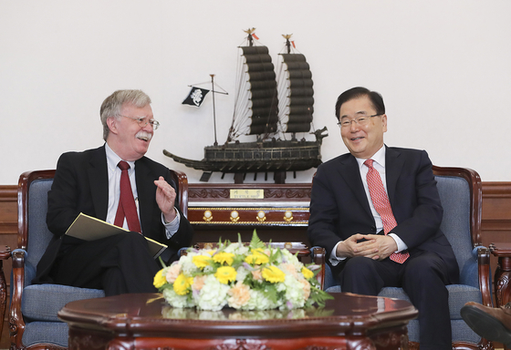 Former U.S. White House National Security Advisor John Bolton, left, and his counterpart Chung Eui-yong, South Korea's Blue House national security office director, hold discussions at the Blue House in July 2019. [YONHAP]