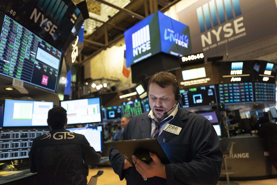 A stock trader works at the New York Stock Exchange on Friday, March 2020. [AP] 