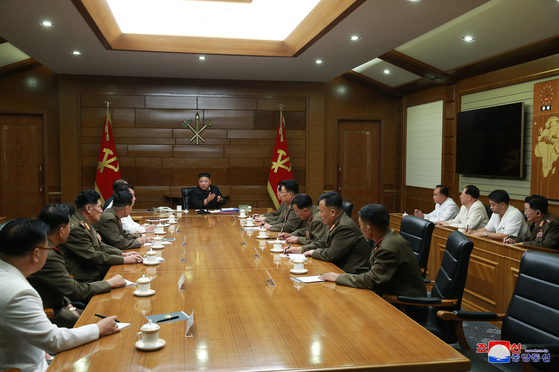 North Korean leader Kim Jong-un, center, presides over a Central Military Commission (CMC) expanded meeting on Saturday, in a photograph released by state media. [YONHAP]