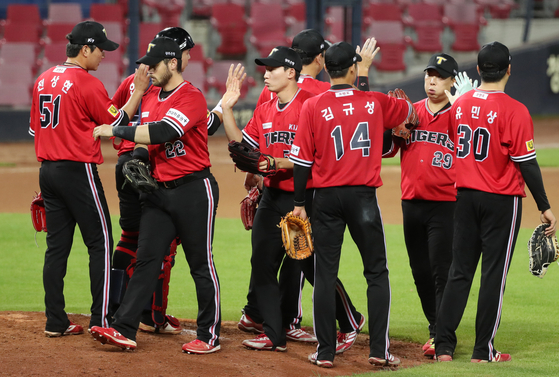 The Kia Tigers players celebrate after picking up a win against the Samsung Lions at Gwangju Kia Champions Field on Sunday. [YONHAP]