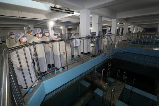 Environment Minister Cho Myung-rae and officials inspect the activated carbon filter at Ttukdo Arisu Water Purification Center in Seongdong District, northern Seoul, on Tuesday, after the Environment Ministry completed nationwide inspections into whether there are larvae entering the tap water of households. [NEWS1] 