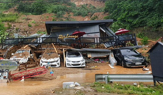 This photo, provided by authorities in northern Gyeonggi, shows holiday lodgings engulfed by a landslide in Gapyeong, Gyeonggi, on Monday. Three people were reportedly killed in the landslide. [NEWS1]