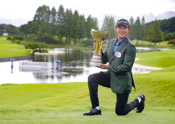 Kim Seong-hyeon poses for a photo with a trophy after picking up a win at the 63rd KPGA Championship with A-One Country Club. [KPGA]