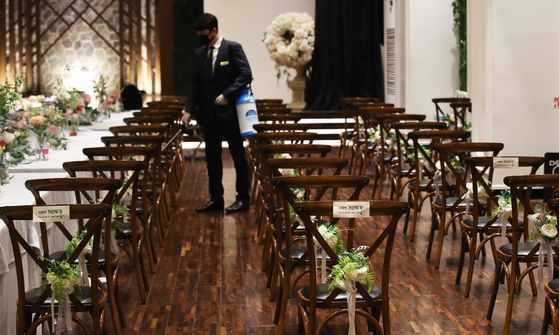 An employee disinfects a wedding hall in Suwon, Gyeonggi, on June 7. [YONHAP]