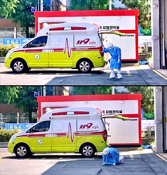 A medical professional sinks to the floor Sunday due to dehydration near a fire station in Jeonju, North Jeolla, as health authorities reported a new five-month high of daily coronavirus cases. [YONHAP]