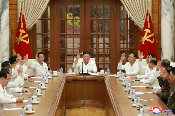 North Korean leader Kim Jong-un, center, convenes a Politburo meeting of the North's ruling Workers' Party Central Committee to discuss preparations for Typhoon Bavi, which is expected to make landfall in the country late Wednesday evening. [YONHAP]