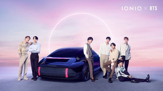 Boy band BTS poses next to a concept car under Hyundai Motor's electric vehicle (EV) brand Ioniq. According to Hyundai Motor on Monday, BTS launched "Ioniq: I'm on it," a brand song dedicated to the EV. It is the first music collaboration between the Korean automaker and the boy band.[YONHAP]