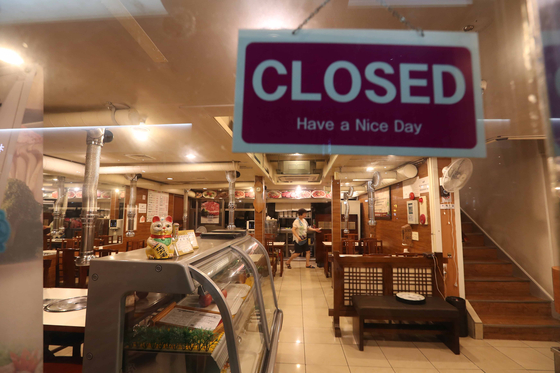 A restaurant in Jung District, central Seoul, is closed Sunday night, after new social distancing guidelines went into effect for the greater Seoul area. Restaurants in Seoul, Incheon and Gyeonggi can allow customers to eat and drink inside their stores up until 9 p.m., after which only takeout orders will be allowed until 5 a.m. [KIM SANG-SEON]