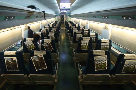 A passenger sits on an empty Korea Railroad (Korail) train from Seoul to Busan on Wednesday. Korail said the hotly contested ticket reservation period for the upcoming Chuseok holiday, that was originally scheduled for Wednesday and Thursday this week, has been pushed back to Sept. 8 to 9 due to Covid-19 concerns. [YONHAP]