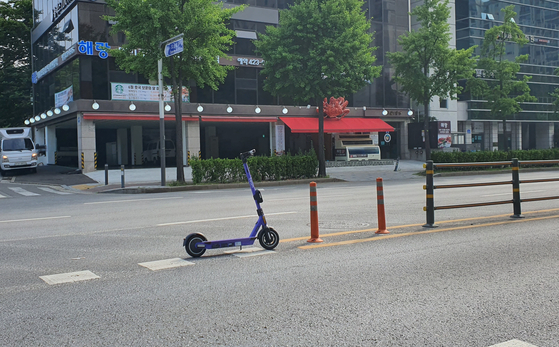 An electric scooter is parked at the center of a road in Songpa District, southern Seoul. [PARK MIN-JE]   