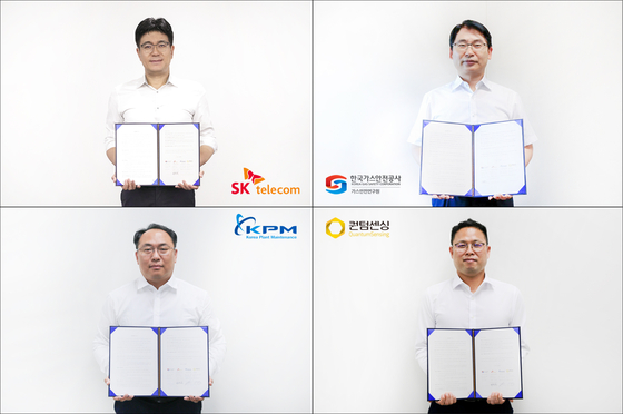 Representatives from SK Telecom, Korea Gas Corp., Quantum Sensing and Korea Plant Maintenance pose with their agreement on Tuesday. [SK TELECOM]