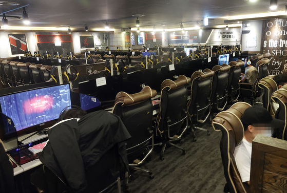 Most of the seats remain empty at an internet cafe, in Seongdong District in eastern Seoul on Monday. While the government has allowed for the opening of internet cafes, restrictions remain. 