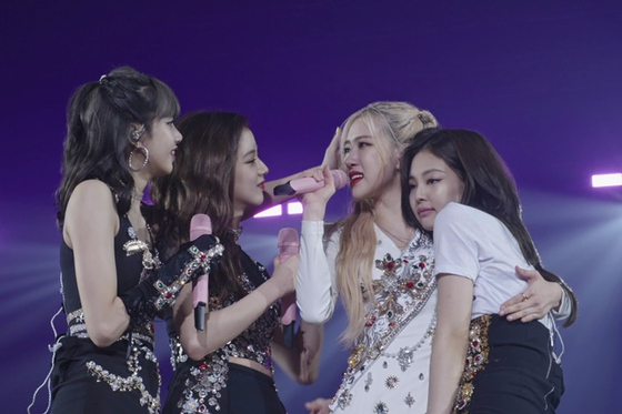 A still image from "Blackpink: Light Up the Sky," which will be released on Netflix on Oct. 14. From left: Lisa, Jisoo, Rosé and Jennie. [NETFLIX]