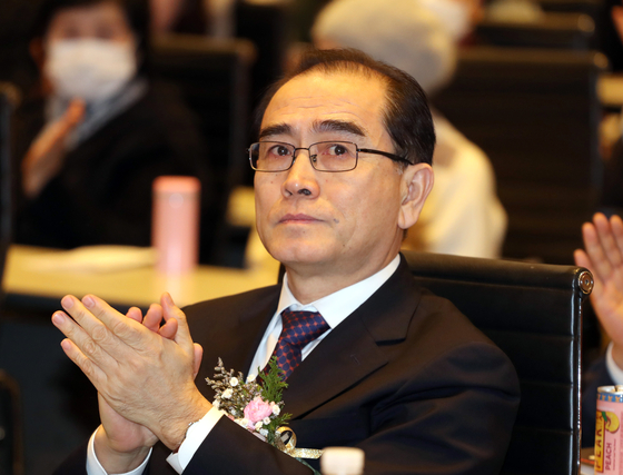 Rep. Thae Yong-ho, North Korea's former deputy ambassador to Britain, claps at a political event in February. [YONHAP]