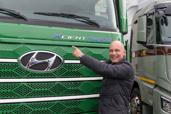 A staff from Travego poses in front of the Xcient Fuel Cell on Oct. 7. [HYUNDAI MOTOR]