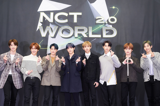 Members of NCT (from left) Sungchan, Kun, Jeno, Taeyong, Winwin, Doyoung, Chenle and Shotaro pose for photos prior to the online press conference for "NCT World 2.0" held on Wednesday afternoon. [MNET]