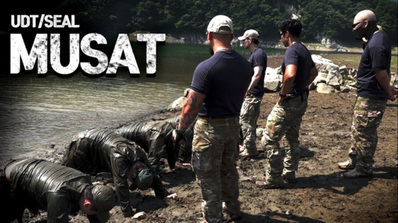 ’Fake Men“ instructors make recruits plant their heads on the ground while keeping their hands behind their back as part of training. [YOUTUBE]