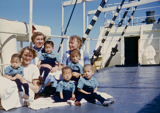 Danish nurses on board the Jutlandia with young Korean civilians who received medical treatment on the vessel. [DANISH JUTLANDIA VETERANS]