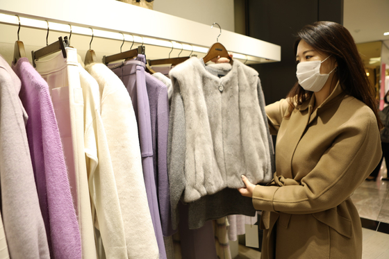 A model shops for winter outerwear at a Lotte Department Store. [LOTTE SHOPPING]