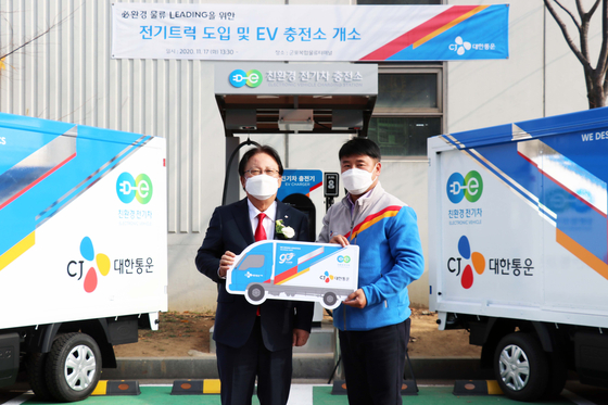 CJ Logistics CEO Park Keun-hee, left, presents an electric delivery truck to an employee in Gunpo, Gyeonggi, at an event held Tuesday to celebrate the opening of an electric vehicle (EV) charging station in the region. [CJ LOGISTICS]