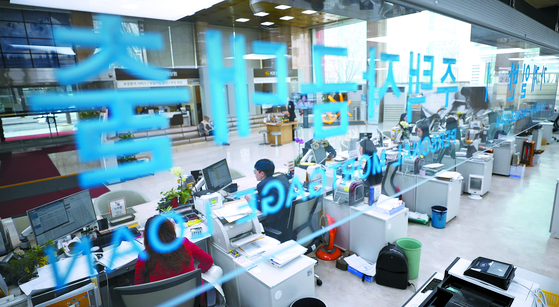 Customers consult with staff about loans at a bank in Seoul. [YONHAP]