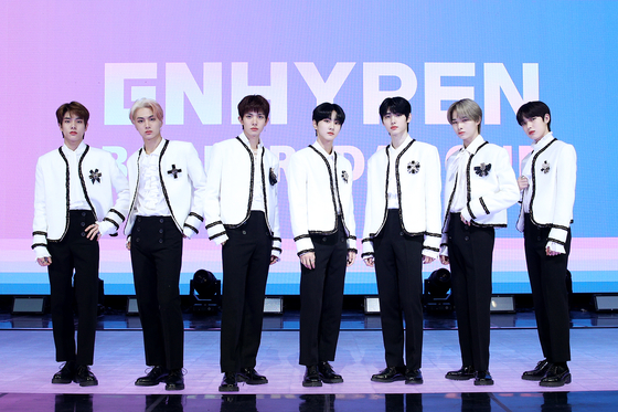 Boy band Enhypen stands for photos on Monday during an online showcase held for its first EP ″Border: Day One.″ [BELIFT LAB]