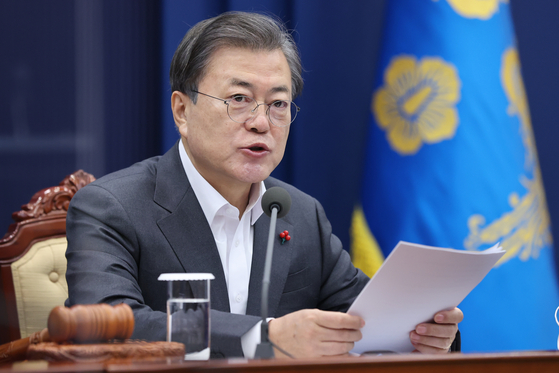 President Moon Jae-in hosts a cabinet meeting via videoconference call from the Blue House on Tuesday.  [YONHAP] 