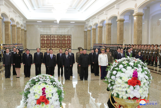 North Korean leader Kim Jong-un, third from left in front row, and his top cadre, including his younger sister Kim Yo-jong, second from left, on Thursday pay tribute to their father and former leader Kim Jong-il on the ninth anniversary of his death, as shown in a photograph from state media. The ceremony took place at the Kumsusan Palace of the Sun, where Kim Jong-il and his father Kim Il Sung's bodies are laid in state. [YONHAP]