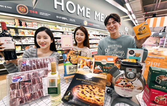 Models pose with products that are part of Homeplus’s promotion for stay-at-home activities, including cooking ingredients and equipment as well as alcoholic beverages at the Gangseo District branch in western Seoul on Wednesday. Homeplus started holding the discount promotion on Wednesday as the demand for domestic appliances is on the rise during the coronavirus pandemic. [YONHAP] 
