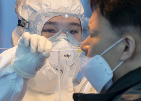 A man gets tested for the coronavirus near Seoul Station in central Seoul Friday. [YONHAP] 