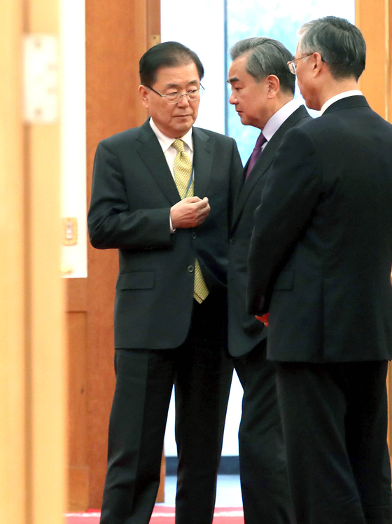 Korean Foreign Minister Chung Eui-yong, left, the former director of the Blue House National Security Office, speaks with Chinese Foreign Minister Wang Yi at the Blue House in central Seoul in a photo from Dec. 5, 2019. [JOINT PRESS CORPS]