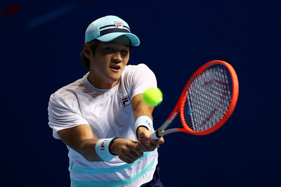Kwon Soon-woo plays a backhand in his men's singles first round match against Thai-Son Kwiatkowski of the United States at the Singapore Tennis Open on Wednesday in Singapore. [GETTY IMAGES]