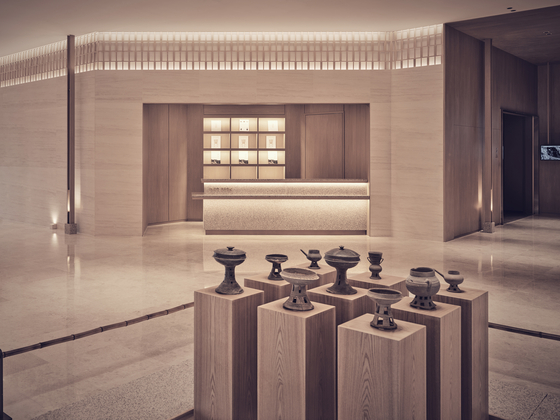 An exposed exhibit displaying Silla artifacts and earthenware welcomes guests at the center of the museum's lobby. [TEO YANG STUDIO]