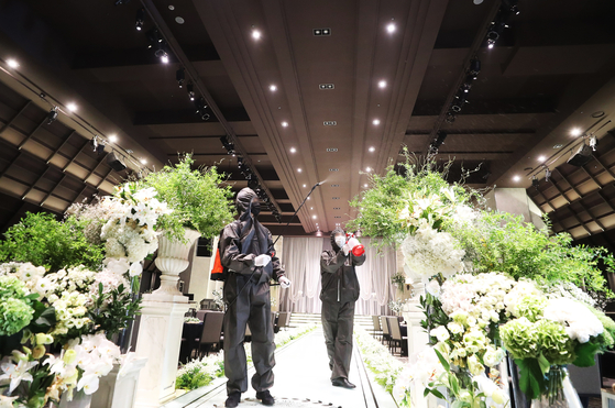 Employees sanitize a wedding hall in Suwon in August 2020. [YONHAP] 
