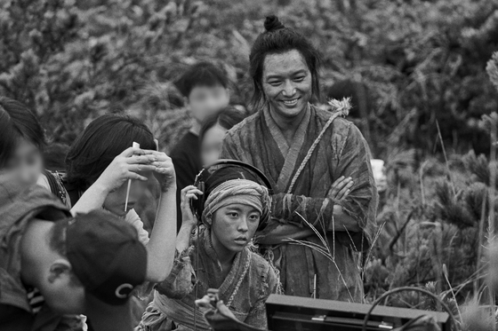 A scene from black and white movie "The Book of Fish" with actor Byun Yo-han, who plays a fisherman named Chang-dae. [MEGABOX PLUS M]