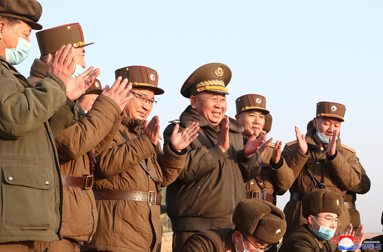 Ri Pyong-chol, third from right, a secretary of the Central Committee of the North Korea’s ruling Workers' Party, claps while watching the successful launch of Pyongyang’s new-type tactical guided missiles Thursday from Hamju, South Hamkyong Province, reported the North’s official Korean Central News Agency Friday. Ri issued a statement Saturday lambasting U.S. President Joe Biden’s remarks criticizing the North’s short-range ballistic missile launches. [YONHAP]