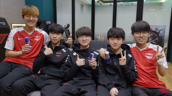 The T1 League of Legends team pose for the camera at their training facility. [T1]