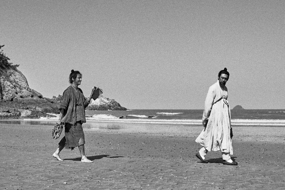 A scene from the black-and-white movie ″The Book of Fish″ with actor Byun Yo-han, who plays a fisherman named Chang-dae, and Seol Kyung-gu, who plays Joseon scholar Jeong Yak-jeon. [MEGABOX PLUS M]             