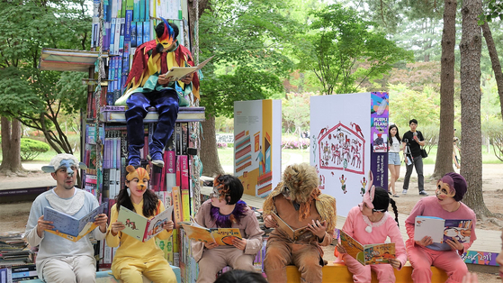 People in costumes gather together to read books at the 2019 edition of the Nami International Children's Book Festival. [NAMI ISLAND]