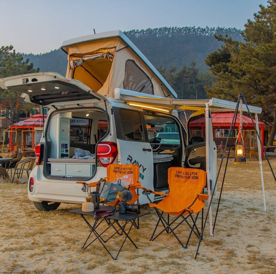 A Kia Ray customized by campervan-maker DaonTnT and nicknamed the Kia Ravy is parked at a campsite. Homeplus held an event on Monday, renting out the vehicle for free to celebrate Korea's "family month."