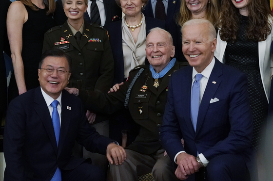 President Joe Biden, right, retired U.S. Army Col. Ralph Puckett, center, and Korean President Moon Jae-in, pose for a photo after Puckett was presented the Medal of Honor in the East Room of the White House on Friday.  [AP] 