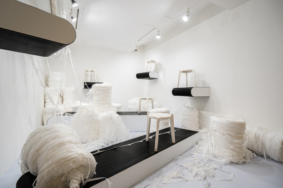 Designer Kim Ha-neul’s “Stack and Stack (In Pandemic),” featuring rolls of plastic fiber used to produce disposable face masks along with stools made from the plastic fiber. [DAELIM MUSEUM]