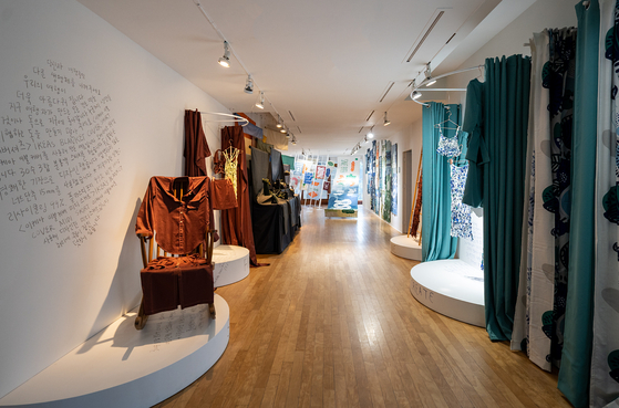 Dresses and fashion items made with discarded fabric and leftover scraps of cloth in the “Fabulous Fabric” section. [DAELIM MUSEUM]