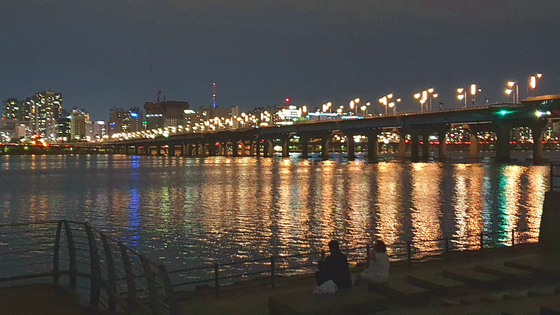People drink right beside the water in Yeouido Han River Park in western Seoul, on May 21 around 11 p.m. [HALEY YANG] 