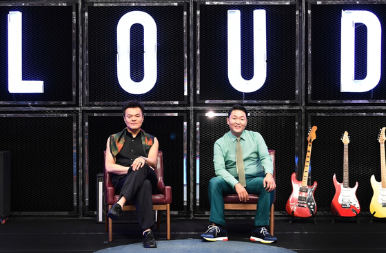 Producers Park Jin-young, left, and Psy pose for the camera at an online press event for the upcoming SBS survival audition program “LOUD” on Thursday. [SBS]
