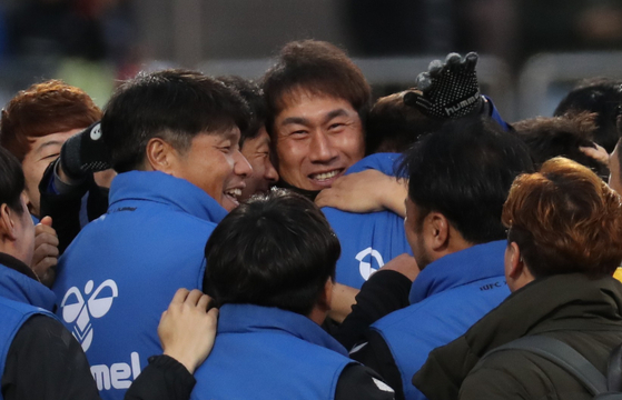 Yoo Sang-chul hugs his team members after Incheon United tied Gyeongnam FC, keeping the Incheon team from being demoted to the second tier league on Nov. 30, 2019. [YONHAP]